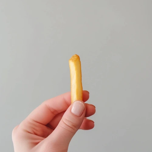 Hand holding a french fry by Midjourney